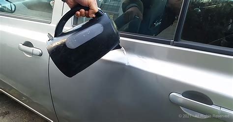 pulling dent from car door.